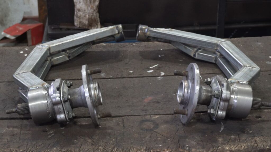Handmade single-sided rear swing arms for a custom tilting trike motorcycle
