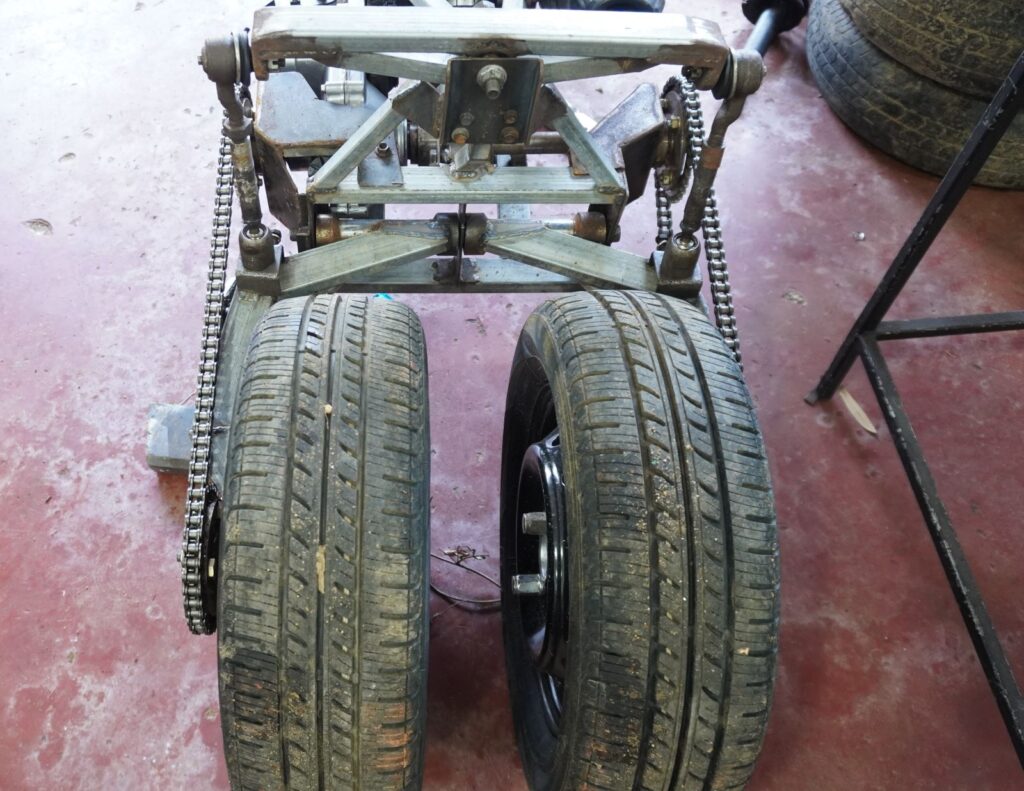 Close rear wheel spacing on a handmade tilting trike motorcycle rear suspension system
