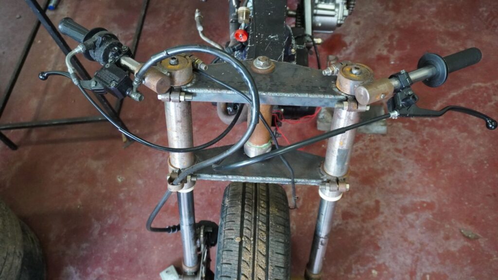 Handmade upside down front fork and steering system on a custom tilting trike motorcycle
