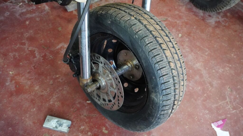 12 inch wheel and tire setup on a handmade tilting trike motorcycle
